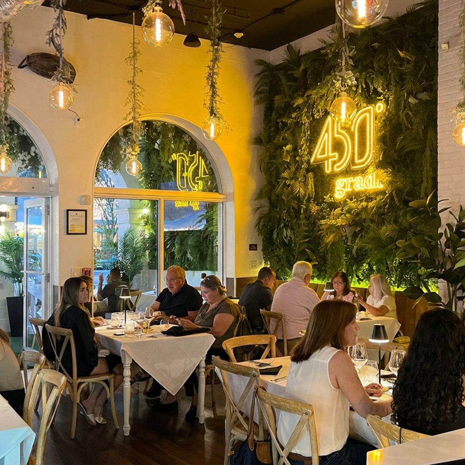 Bustling restaurant dining room with white tablecloths, hanging globe lights, lush greenery, and a glowing 4D Grill sign.